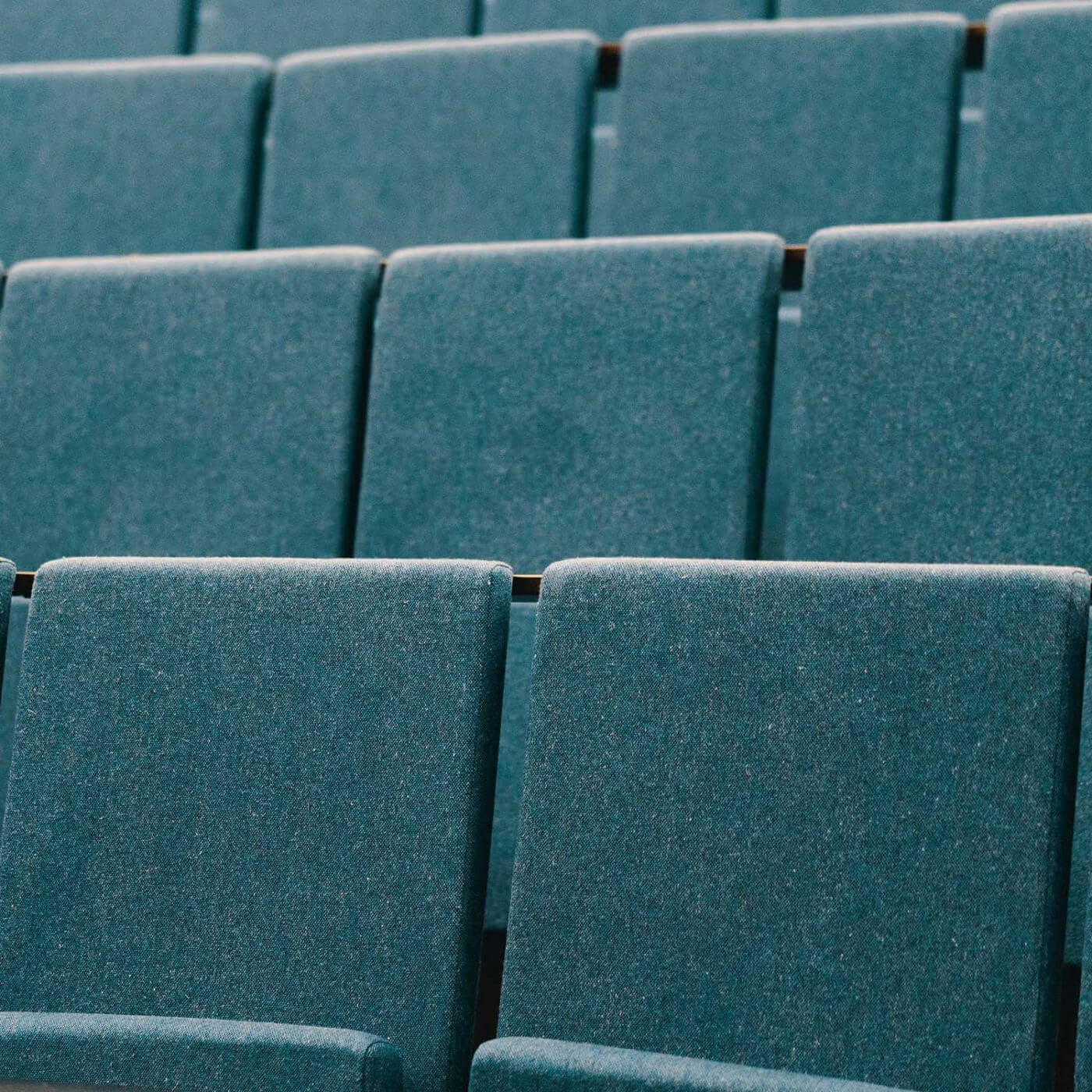 A closeup of seats in a classroom with stadium seating.